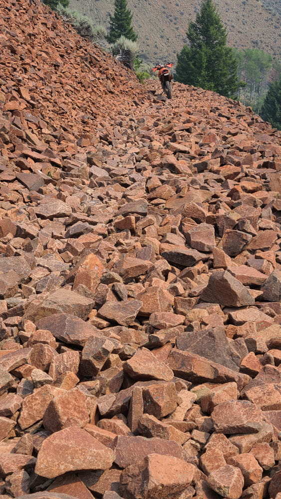 a motorcycle parked on rocky trail