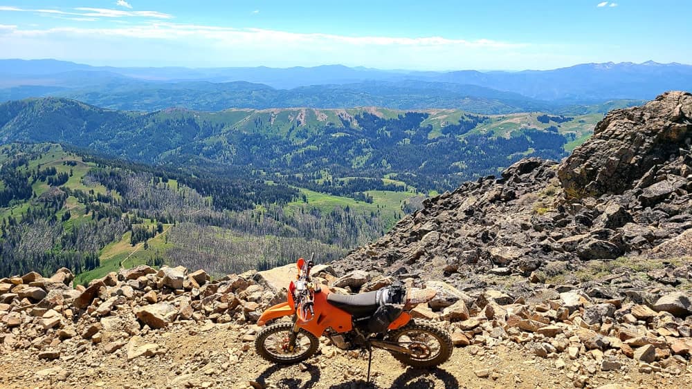 motorcycle parked high above mountains