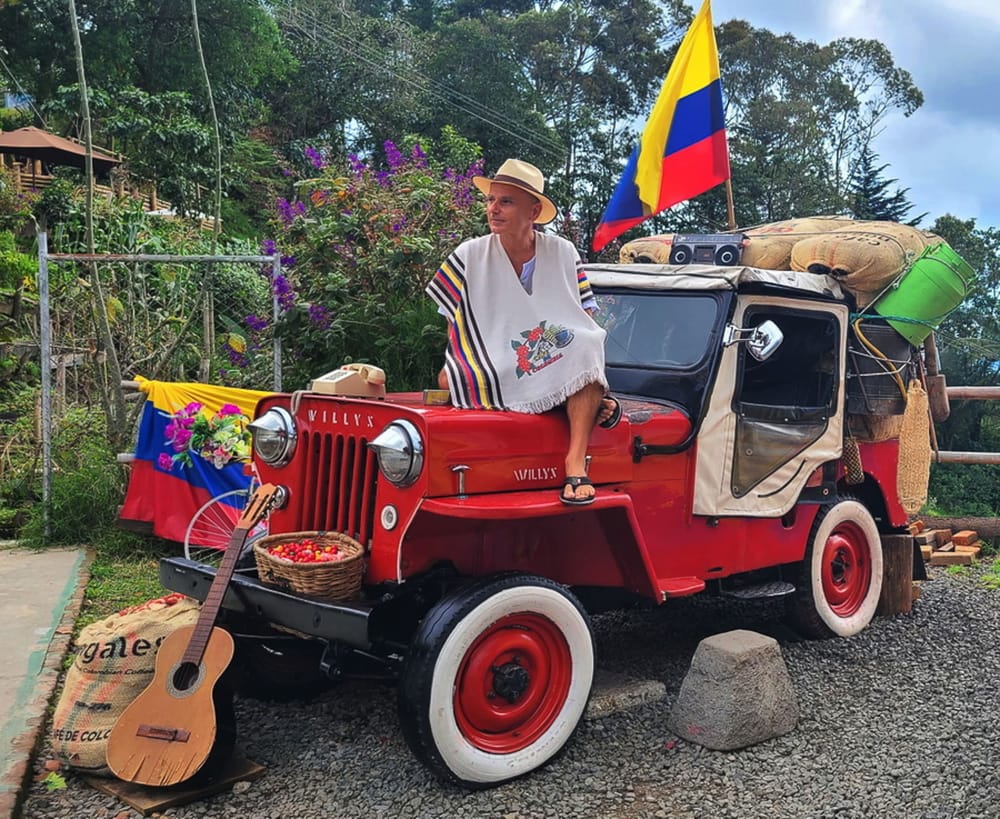sitting on a red jeep with coffee bags next to it