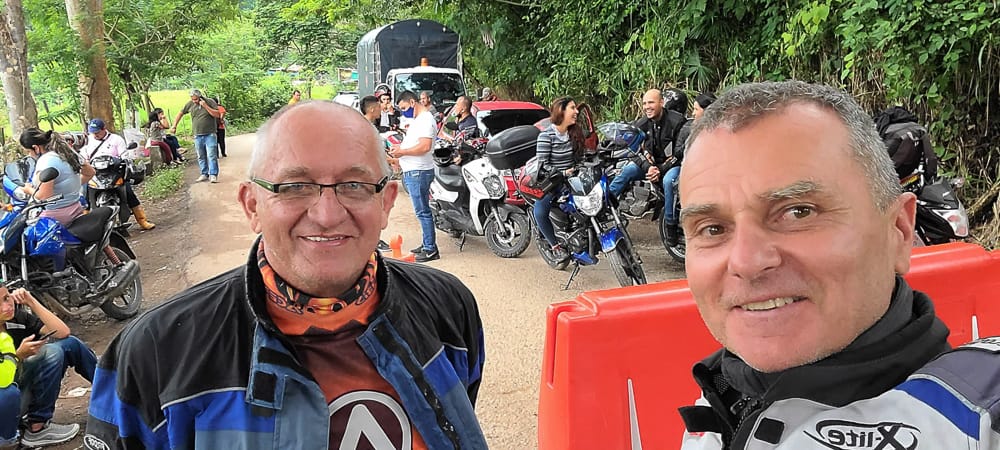  selfie with a group of riders and cars waiting at a road block