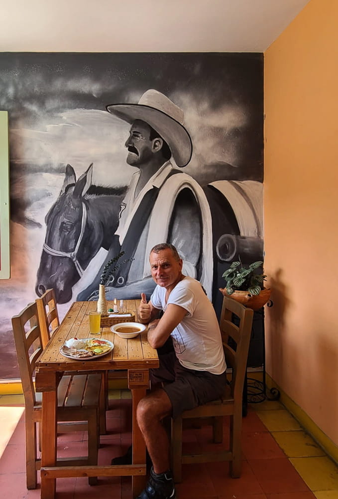  sitting in a restaurant next to wall painting