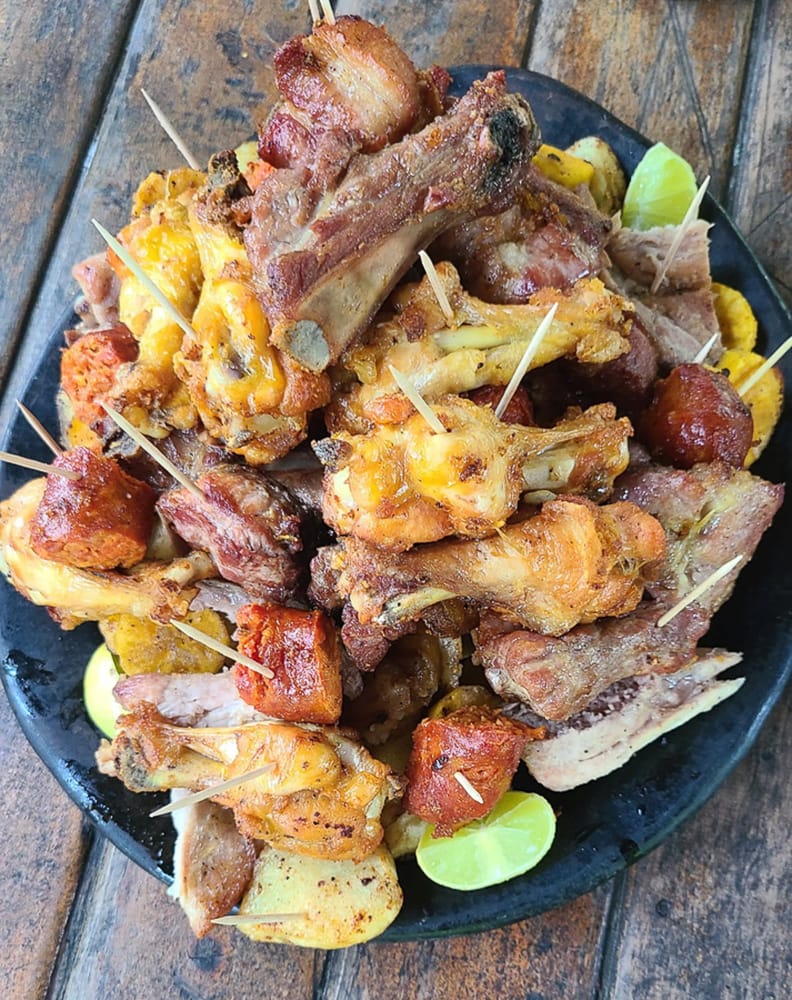  a plate of grilled meats and potatoes 