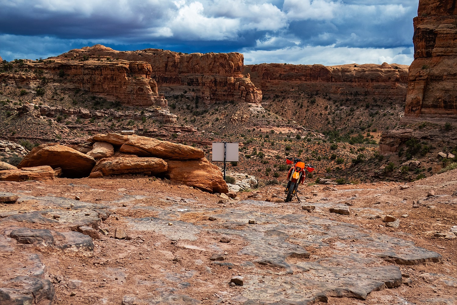 motorcycle parked with a canyon behind