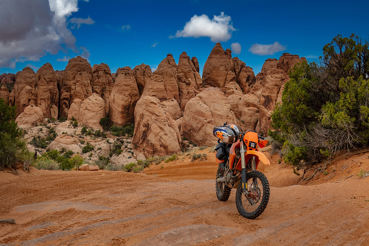 motorcycle parked with rock spires behind