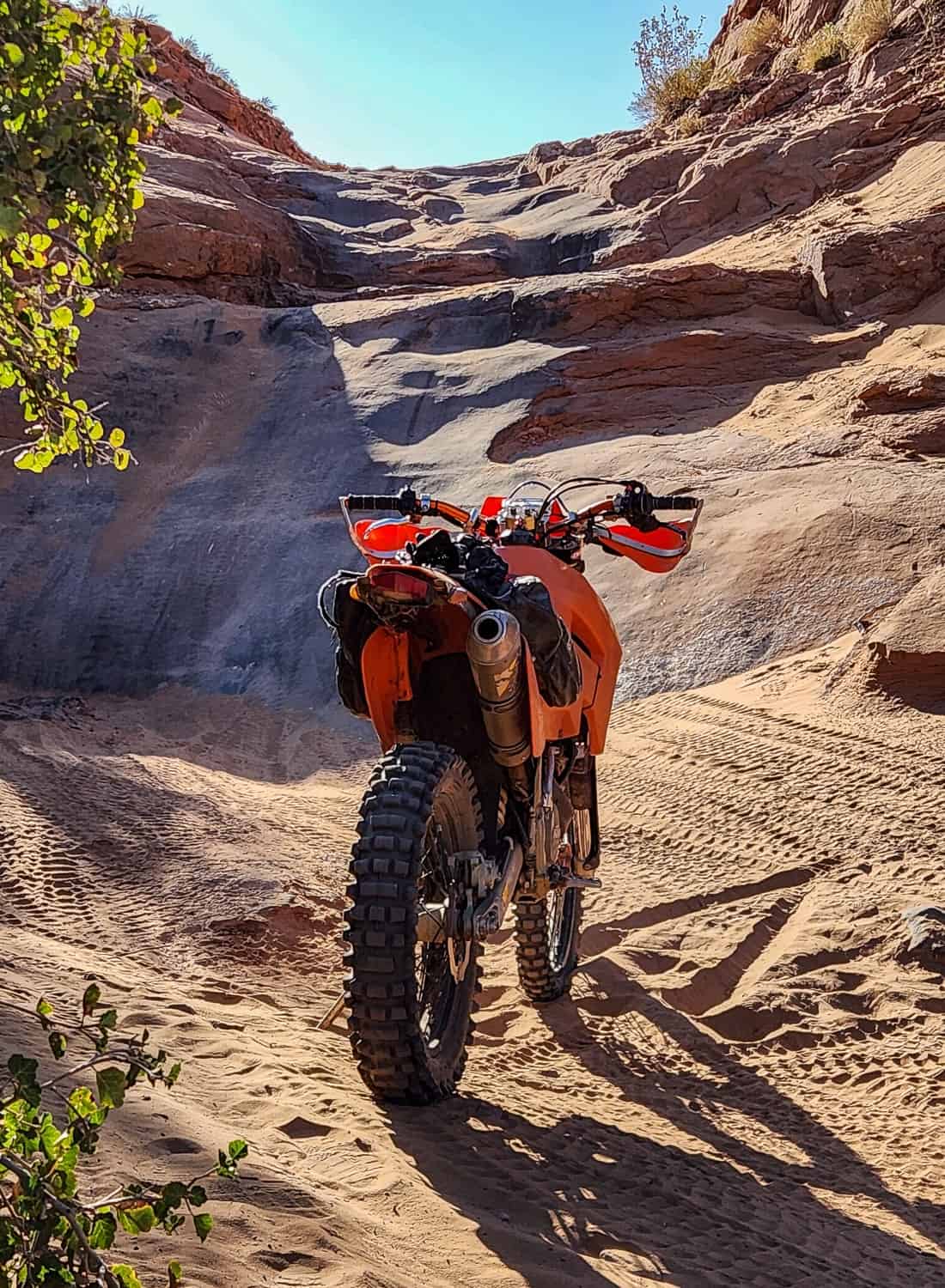 motorcycle in front of a steep rocky incline