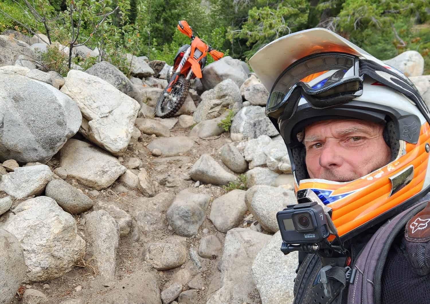 selfie with a motorcycle surrounded by large rocks