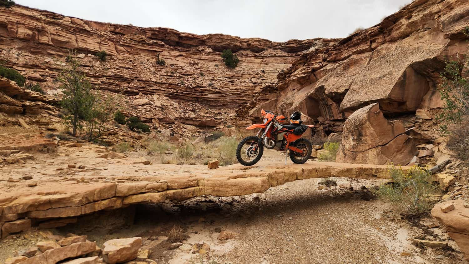 motorcycle parked on a natural rock bridge