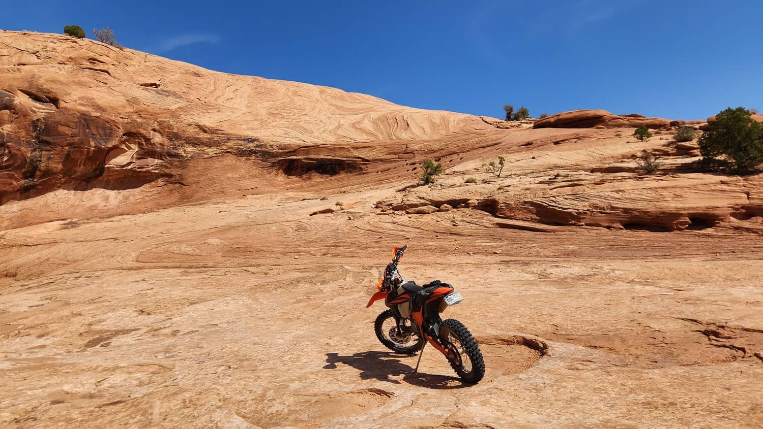 motorcycle parked at the bottom of a steep hill