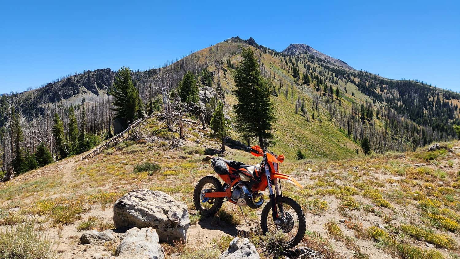 motorcycle on a trail running along a mountain ridge
