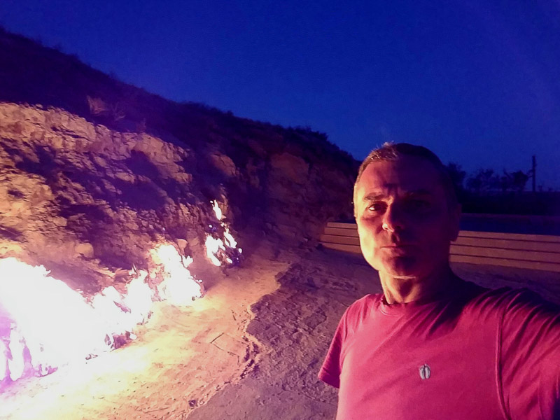 selfie next to a flames coming out of ground