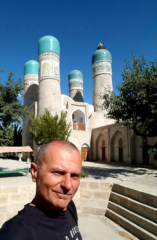 selfie with a four-minaret white mosque behind