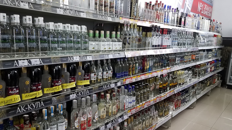superkarket shelves full of various vodka brands