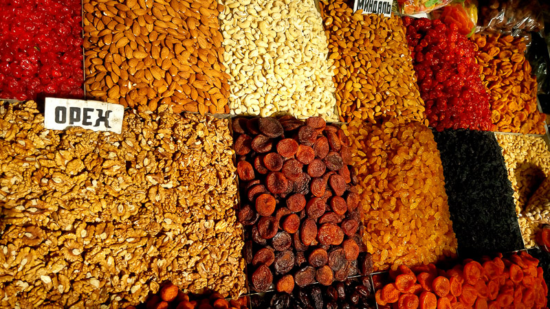 various dried fruits and nuts on display in a market