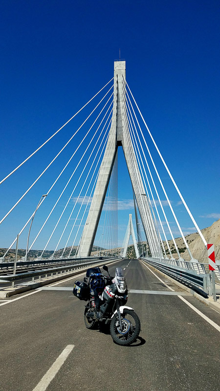 motorcycle parked on a suspension bridge