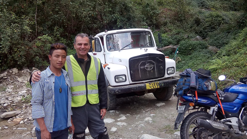two guys in front of an old truck