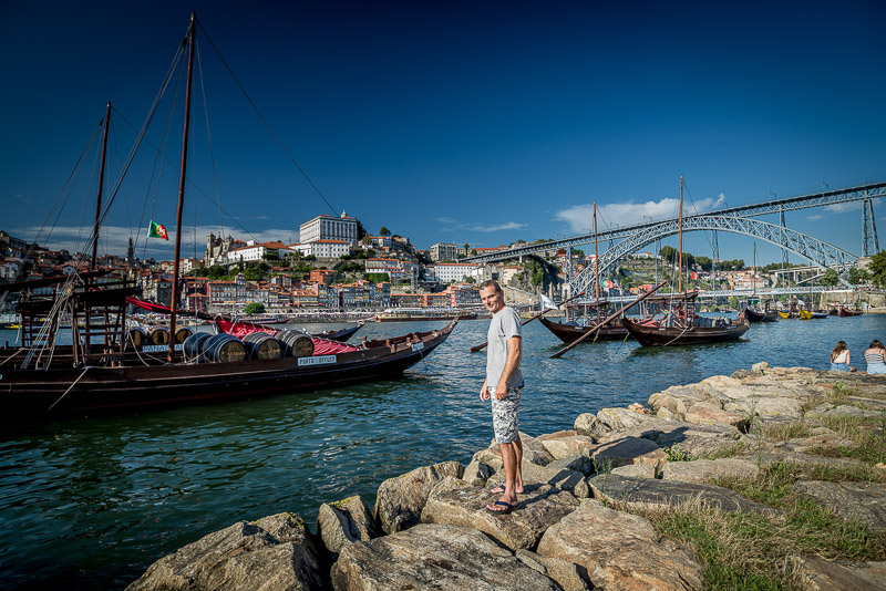 Traditional boats anchored in Porto with a high bridge behind