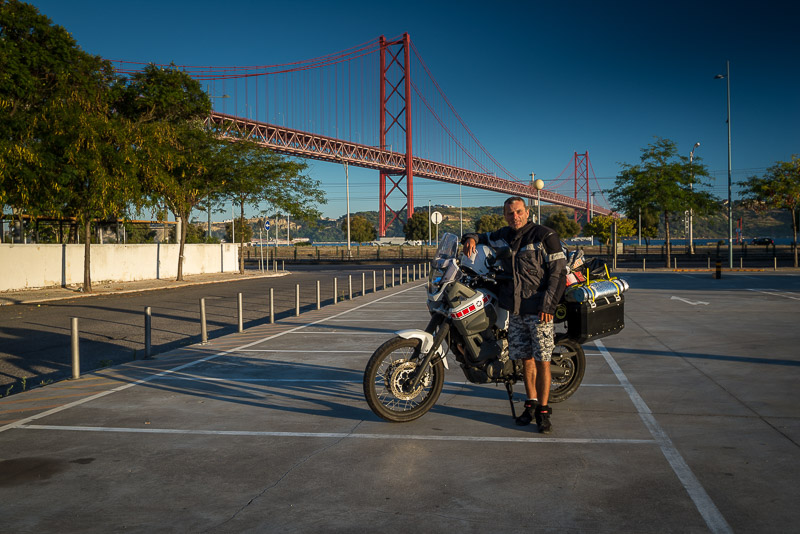 Posing with motorcycle in front of Lisbon bridge