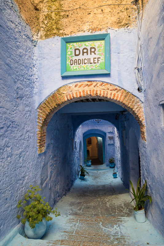 Narrow alley with houses painted in light blue