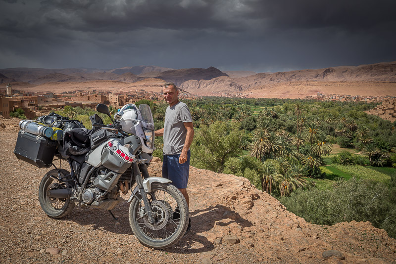 Posing with motorcycle next to an oasis