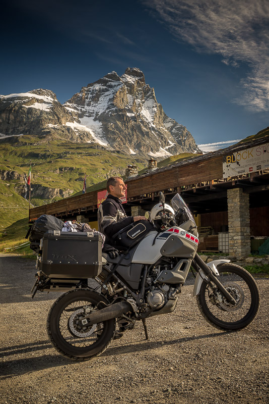 posing with a motorcycle at the base of Mt Cervino