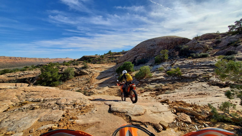 three riders by ancient rock dwellings