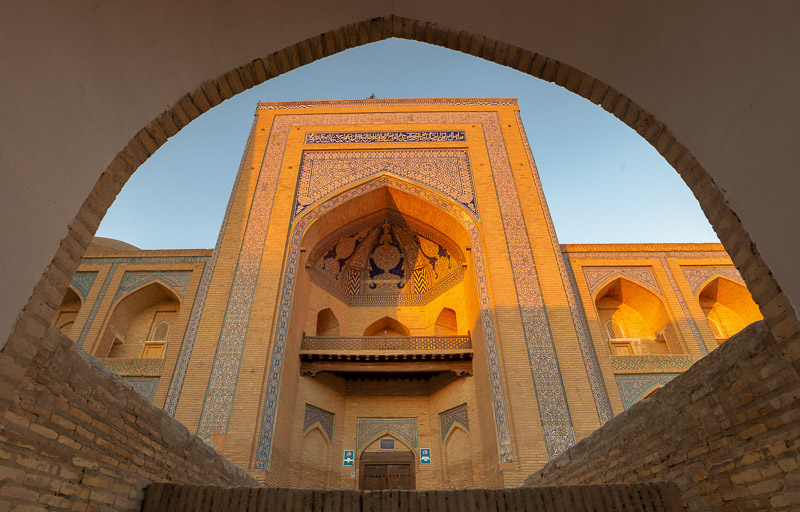 front entrance of a building framed by the gate