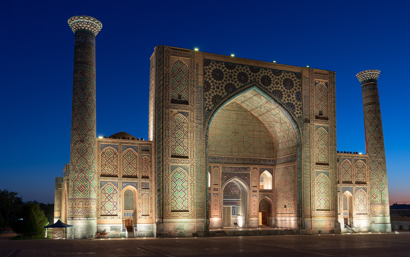 central asia-style mosque with two minarets at dusk
