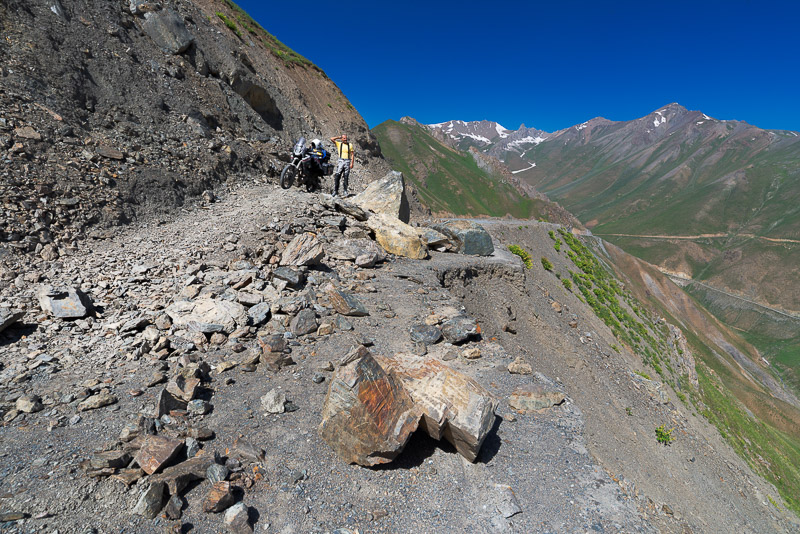 posing with the motorcycle atop a rockslide