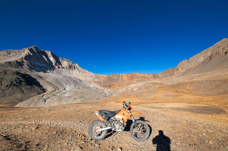 motorcycle parked with baren peak behind