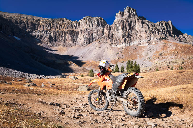 motorcycle parked with baren peak behind