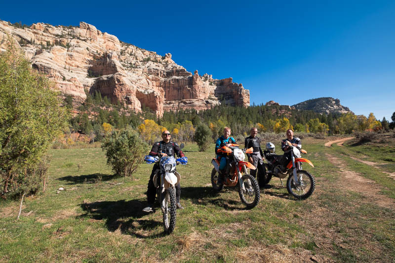 motorcycle riders posing in a canyon