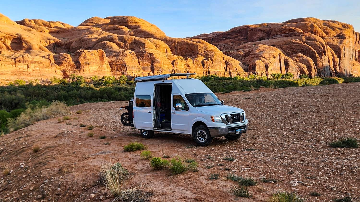 van with red cliffs behind