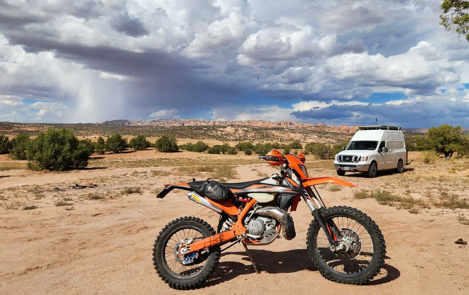 van  and dirt motorcycle in Utah desert