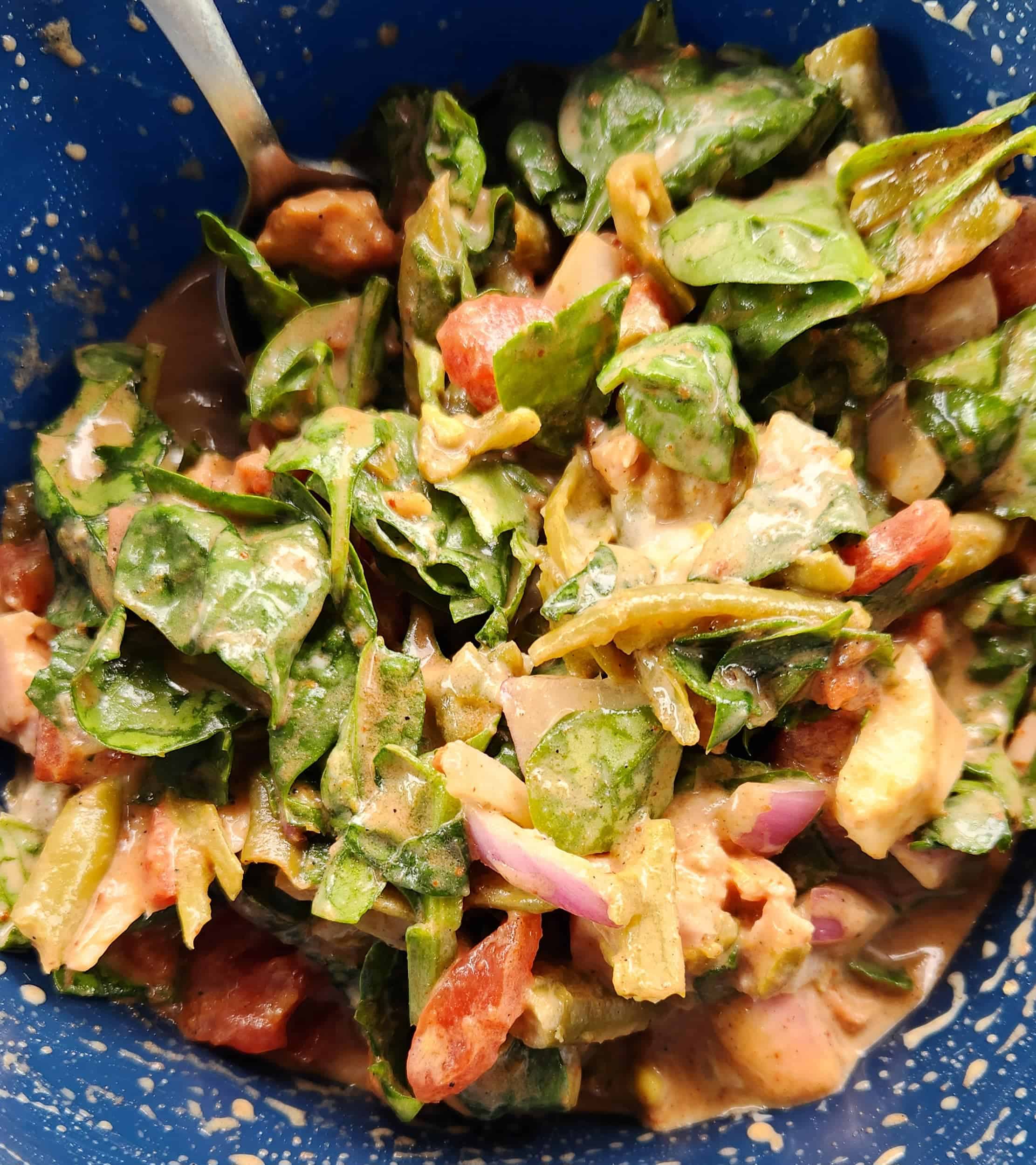 salad with red onions, spinach and diced tomatoes